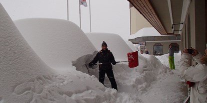 Pensionen - Kühlschrank - Rattendorf - 2014 schneereichster Winter, mein Gast beim Ausschaufeln seines Autos - Appartement Sonja im Haus Carinthia am Nassfeld