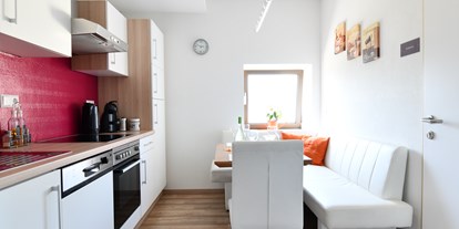 Pensionen - Terrasse - Wernzach - Küche im Studio -  befindet sich im 2. Stock - mit Eckbank und Sessel für 4 -5 Personen - Posthostel Lavamünd